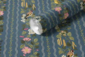 Hedgerows wallpaper by Studio Le Cocq in navy, partly unrolled roll showing hedgerow flowers and birds in stripes