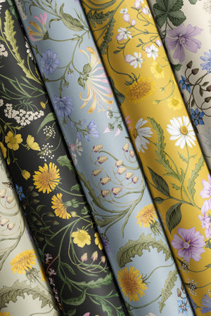 The Lost Garden Cottage wallpaper by Studio Le Cocq in cream, sample roll showing a dense garden of flowers