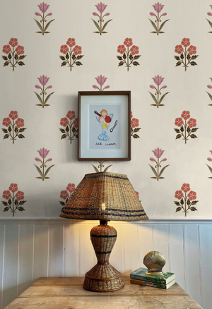 Sultana wallpaper by Deus ex Gardenia in pink and red, a vertical floral motif above a sideboard