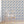 Forget Me Not wallpaper by Seed Home Designs in blue, scattered forget-me-nots behind a sofa in a living room
