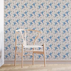 Forget Me Not wallpaper by Seed Home Designs in blue, scattered forget-me-nots behind a sofa in a living room