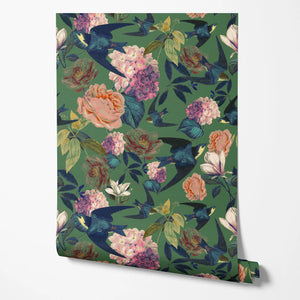 Swallows and Blooms wallpaper by Tatie Lou in green, partly unrolled roll showing swallows and peonies