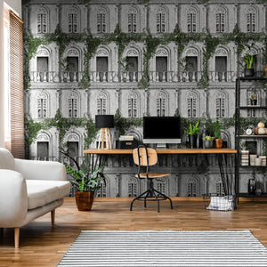 The Architecture wallpaper by Brand McKenzie in grey, overgrown classical buildings behind a desk in a home office