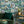 The Art Deco Hills wallpaper by Brand McKenzie in aqua, Art Deco hillside scenes in a living room