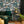 The Art Deco Hills wallpaper by Brand McKenzie in teal, Art Deco hillside scenes on a living room wall
