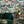 The Art Deco Hills wallpaper by Brand McKenzie in fuchsia, Art Deco hillside scenes on a living room wall