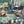 The Art Deco Hills wallpaper by Brand McKenzie in fuchsia, pattern detail of Art Deco hillside scenes