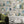The Cabinet wallpaper by Brand McKenzie in grey, a cabinet of curiosities in a living room