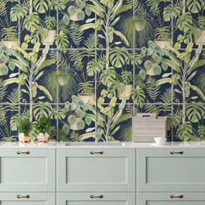 The Green House wallpaper by Brand McKenzie in navy, glasshouse plants above a sideboard