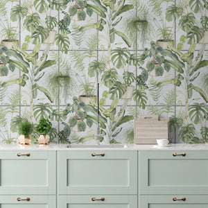 The Green House wallpaper by Brand McKenzie in blue, glasshouse plants above a sideboard