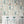 Liquid Lab wallpaper by Brand McKenzie in cream, bottles and laboratory glassware behind bar stools