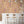 Liquid Lab wallpaper by Brand McKenzie in peach, bottles and laboratory glassware in a kitchen