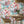 The Mediterranean wallpaper by Brand McKenzie in pink and aqua, a whitewashed hillside village in a dining area