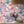 The Mediterranean wallpaper by Brand McKenzie in lilac and pink, close view of a whitewashed hillside village