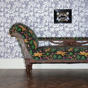 Passion Flower wallpaper by The Monkey Puzzle Tree in lilac and silver, passion flowers covering an armchair