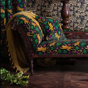 Passion Flower wallpaper by The Monkey Puzzle Tree in gold and black, passion flowers on an upholstered chair