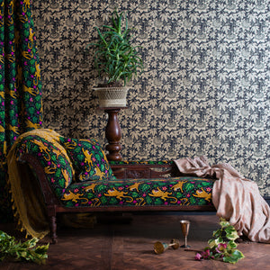 Passion Flower wallpaper by The Monkey Puzzle Tree in gold and black, passion flowers upholstered on an armchair