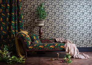 Passion Flower wallpaper by The Monkey Puzzle Tree in gold and black, passion flowers upholstered on an armchair