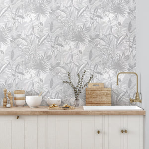 The Tropics wallpaper by Brand McKenzie in grey, tropical leaves and birds above a cabinet