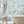 Tiger Lily wallpaper by Brand McKenzie in pale blue, tigers among lilies in a bathroom setting