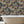 Tiger Lily wallpaper by Brand McKenzie in charcoal and gold, tigers among lilies on a bathroom wall