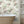 Tiger Lily wallpaper by Brand McKenzie in cream and green, tigers among lilies in a bathroom setting