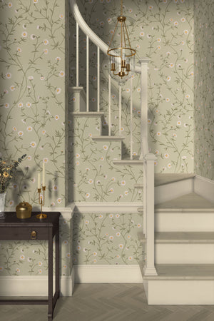 Daisy Chain wallpaper by Studio Le Cocq in sage green, trailing daisy chains in a hallway