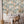 Travel Map wallpaper by Brand McKenzie in beige and sage green, an illustrated travel map behind a desk in a home office