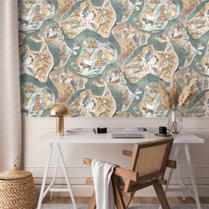 Travel Map wallpaper by Brand McKenzie in beige and sage green, an illustrated travel map behind a desk in a home office