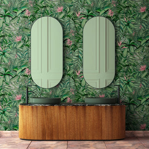 Tropical Forest wallpaper by Brand McKenzie in green and pink, tropical leaves in a bathroom