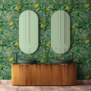 Tropical Forest wallpaper by Brand McKenzie in green and yellow, tropical leaves on a bathroom wall
