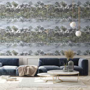 Tropical Reflections wallpaper by Brand McKenzie in green, palms reflected in water behind a sofa in a living room