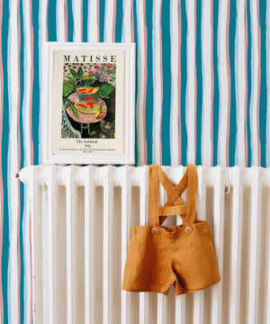 Beside the Seaside wallpaper by Annika Reed in teal, seaside stripes above a sideboard