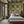 Versailles wallpaper by Liberty James Studio in green and gold, an ornate kaleidoscope design in a bedroom