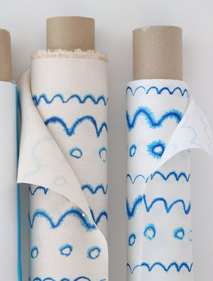 Circles in the Waves linen by Seed Home Designs in blue and white, partly unrolled roll showing