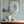 Wiggly Squiggly wallpaper by Annika Reed in teal and yellow, wiggly waves above a cabinet