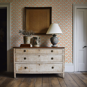 Wiggly Squiggly wallpaper by Annika Reed in peach, wiggly waves behind a console table