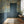 Wisteria Rainfalls wallpaper by Dami and Em Design in teal, falling wisteria in a hallway