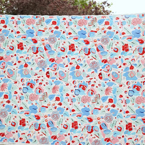 A Fresh Birth linen by Claire de Quénetain in blue, draped, showing a hand-painted floral design