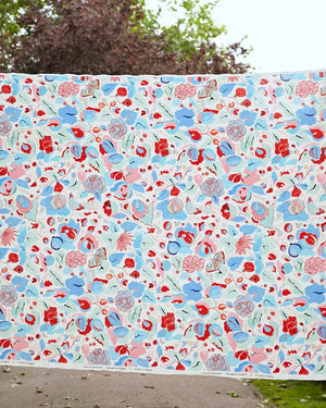 A Fresh Birth linen by Claire de Quénetain in blue, draped, showing a hand-painted floral design