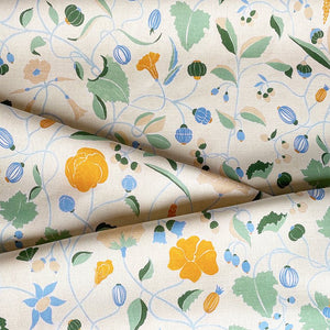 Adrienne linen by Claire de Quénetain in orange, draped, showing a hand-painted floral design
