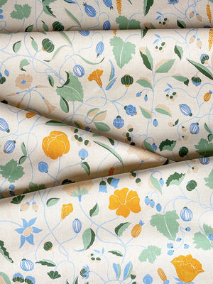 Adrienne linen by Claire de Quénetain in orange, draped, showing a hand-painted floral design