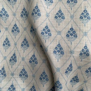 Agra linen by Annika Reed in blue, draped, showing block-print flowers in a trellis