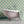 Aphrodite wallpaper by Annika Reed in green, scallop shells on a bathroom wall