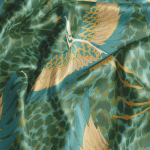 Pachamama velvet by Tatie Lou in green, draped, showing flying cranes