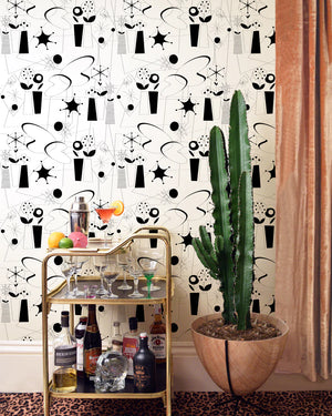 Atomic wallpaper by Dupenny in black and white, atomic-age motifs in a styled room setting