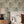 Aviary Isle wallpaper by Deus ex Gardenia in pale blue, birds among island flowers behind a bed