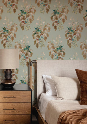 Aviary Isle wallpaper by Deus ex Gardenia in pale blue, birds among island flowers behind a bed