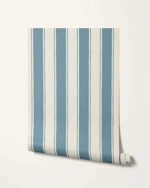 Balancing Act wallpaper by Annika Reed in blue, partly unrolled roll showing hand-painted stripes