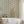 Mermaids in Seashore wallpaper by Annika Reed in cream and green, mermaids in wreaths on a bathroom wall